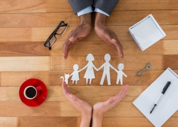 Cutout paper chain family with the protection of hands on table