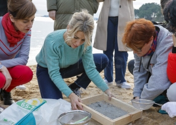 POBRA DO CARAMIÑAL, A CORUÑA 12/01/2024.- La vicepresidenta segunda del Gobierno y líder de Sumar, Yolanda Díaz, y la candidata de Sumar Galicia a la Xunta, Marta Lois, (izq) comprueba el funcionamiento de las labores de limpieza de granza o pellets, esta tarde en la Playa de la Corna, en Pobra do Caramiñal. EFE/Lavandeira jr