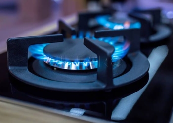 Stove. Cook stove. Modern kitchen stove with blue flames burning.